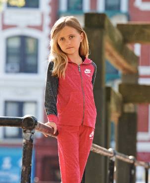 Little girl posing in sweater hoodie.